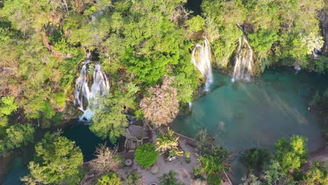 Aerial-view-of-amazing-Tamasopo-waterfalls-surrounded-by-trees-in-San-Luis-Potosi,-Mexico