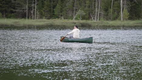 Man-Canoeing-On-Serene-Lake-At-Forest-Resort-Of-Le-Vertendre-In-Quebec,-Canada