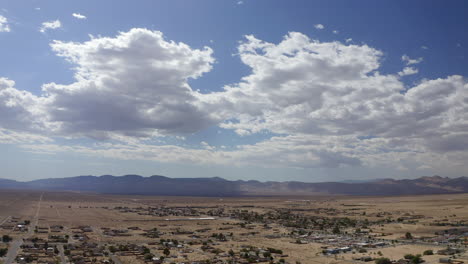 A-sprawling-city-in-the-Mojave-Desert-basin-with-mountains-in-the-distance---aerial-view