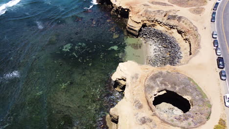 Sunset-cliffs-cave-and-boulvard-in-San-Diego,-aerial-drone-view