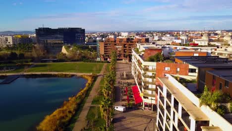 drone-flight-over-a-lake-and-mordern-residential-buildings-in-the-middle-of-the-city