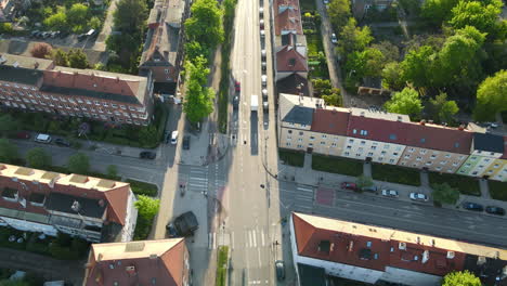 Aerial-drone-flight-showing-road-with-driving-cars-in-old-town-of-Gdansk-during-sunny-day
