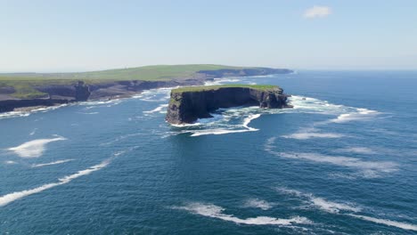 Aerial-approach-towards-Illaunonearaun-islet-with-Kilkee-cliffs-in-the-background