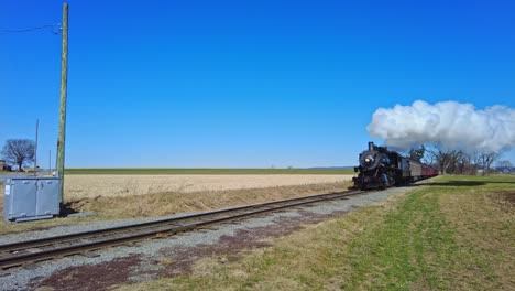 An-Approaching-Steam-Passenger-Train-Blowing-Smoke-and-Steam-on-a-Sunny-Day