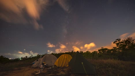 Tents-under-Milky-Way-Galaxy-Time-Lapse-Mui-Wo,-Hong-Kong,-Universe-galaxy-milky-way-time-lapse,-dark-galaxy-view,-star-lines,-traffic-lights-time-lapse-hyperlapse-night-sky-stars-on-sky-background