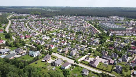 AERIAL-Side-Panning-Shot-of-the-Suburbs-of-a-small-town-Ukmerge-in-Lithuania