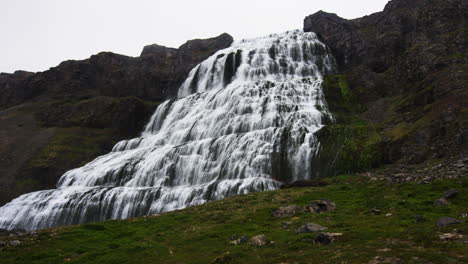 Wide-and-massive-waterfall-on-tall-mountain-in-low-angle-zoom-in-view