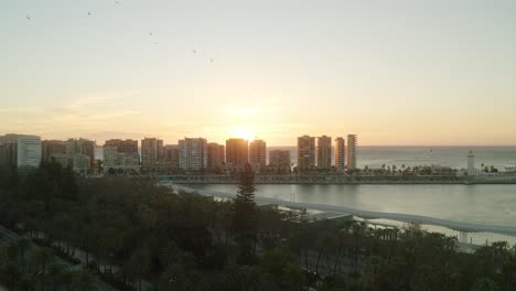 Epic-sunrise-behind-the-skyscraper-buildings-on-the-harbor-of-Malaga-early-in-the-morning