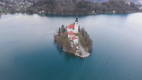 Charming-autumn-panorama-landscape-of-island-with-church-rounded-colorful-trees-in-the-middle-of-Bled-lake