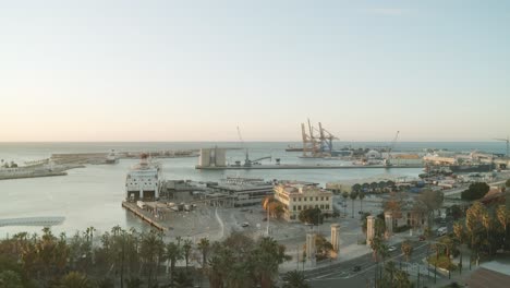 Wide-shot-showing-industrial-harbor-and-port-of-Malaga-with-cranes-and-shipyard-during-sunrise