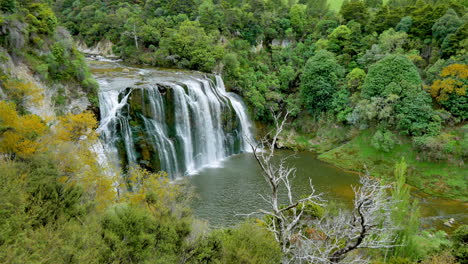 Aerial-shot-of-beautiful-idyllic-Mangatiti-Falls-surrounded-by-green-jungle