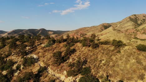 A-beautiful-rushing-pan-taken-from-a-drone-revealing-Red-Rocks,-Morrison-Colorado