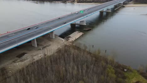 Ascend-backwards-shot-of-traffic-on-polish-bridge-build-to-cross-Wisla-Vistula-River