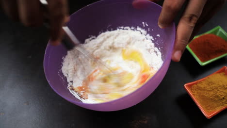 chef-mix-the-mixture-of-corn-flour-,egg-,red-chilly-powder-and-salt-by-the-whisker