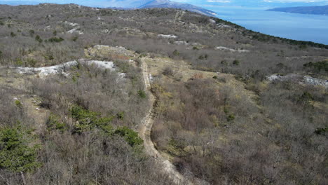 4K-drone-over-mountain-road-in-Croatia,-overlooking-the-Adriatic-Sea