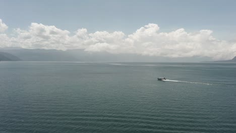 Motorboat-on-Atitlan-Lake-and-surrounding-landscape,-Guatemala