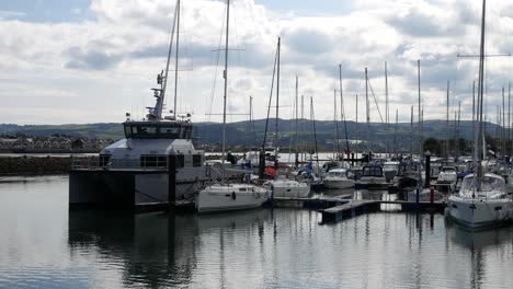 Fisheries-boats-and-yachts-moored-on-sunny-luxury-Conwy-Welsh-marina-North-wales