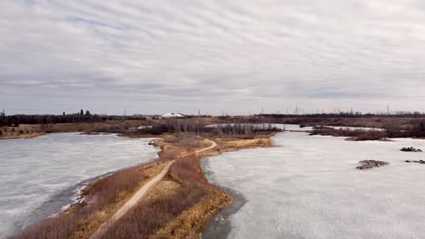 Drone-Moving-Up-Park-Path-Frozen-Pond