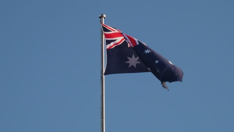 Flag-Of-Australia-Swaying-On-The-Wind-With-Blue-Sky-On-The-Background