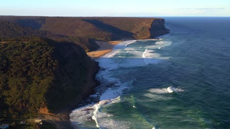 Cliffs-And-Vegetation-Surrounding-Garie-Beach-On-The-New-South-Wales-Coast,-Royal-National-Park,-Australia---aerial-drone-shot