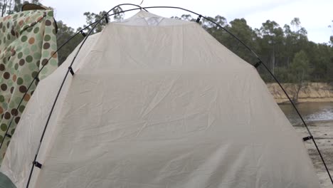 Outdoor-nature-woman-packing-up-tent-sheet-camping
