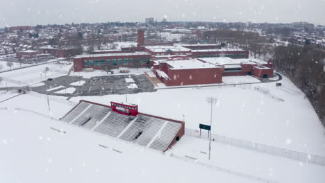 Winter-snow-falls-at-school,-college-university-campus-athletic-fields