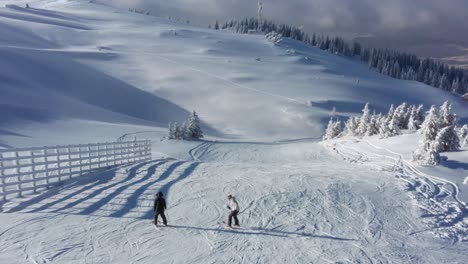 Beginner-skiers-falling-over-on-mountain-ski-resort-ski-slopes,-4K-aerial-view