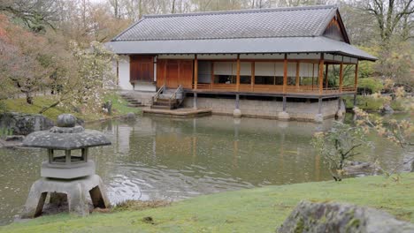 Ceremony-House-Sits-By-A-Tranquil-Pond-In-The-Japanese-Garden-In-Hasselt,-Belgium---wide-static-shot