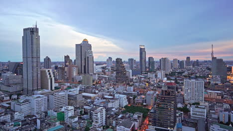 Bangkok-downtown-city-panorama-overview-on-sunset-from-high-point-of-view-showing-numerous-skyscrapers-and-business-centers-from-top,-Thailand