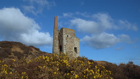 Clouds-cast-shadows-over-old-stone-mine-on-hill-in-Cornwall,-UK
