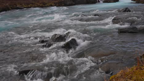 Rapid-River-Flow-Rushing-Through-The-Stones-At-River-Bruara,-Golden-Circle,-Southwest-Iceland---tilt-down-shot