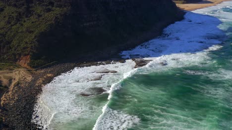 Foamy-Sea-Waves-Washing-Rocky-Shore-At-Royal-National-Park-In-New-South-Wales,-Australia---aerial-shot
