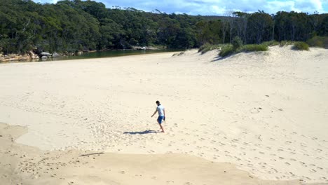 Guy-Walking-On-White-Sandy-Shore-During-Sunny-Day-Near-North-Era-Campground-In-Royal-National-Park,-New-South-Wales,-Australia