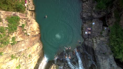 Man-Jumping-From-Cliff-At-Sai-Kung-Rock-Pools-In-Sai-Kung,-Hong-Kong
