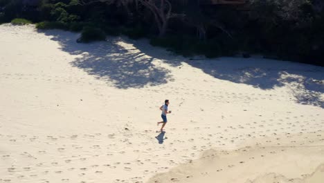 Barefooted-Guy-Running-On-Sandy-Coast-At-Summer-Beach-Near-North-Era-Campground-In-Royal-National-Park,-NSW-Australia