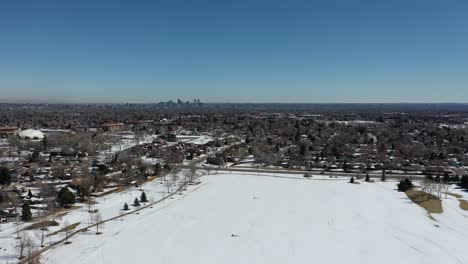 A-drone-shot-over-a-park-outside-of-Denver-after-a-spring-snowstorm