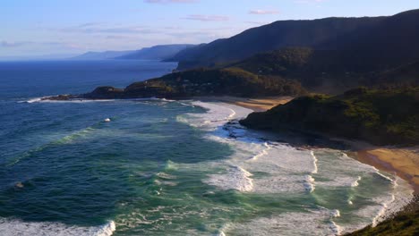 Idyllic-Scenery-With-Ocean-And-Lush-Hills-At-North-Era-Beach-In-Royal-National-Park,-New-South-Wales,-Australia---aerial-static-shot