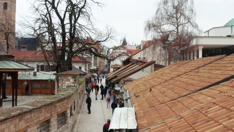 Sarajevo-old-city-streets,-people-walking-through-historic-streets,-aerial-view