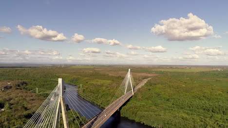 Aerial-backward-rising-over-Mauricio-Baez-Bridge,-Dominican-Republic