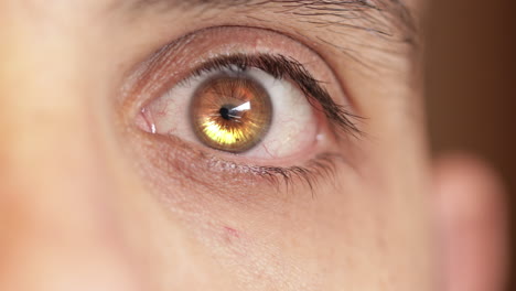Sci-fi-eye,-closeup-of-man-'s-gold-opening-eye