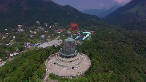 Aerial-circling-over-Tian-Tan-Buddha-big-statue-on-Lantau-Island,-Hong-Kong