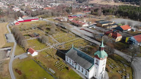 Aerial---Björketorps-Church-and-cemetery,-Rävlanda,-Härryda,-Sweden,-wide-shot