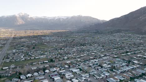 Ogden-city-in-Utah,-with-Wasatch-Mountains-in-background,-aerial-panoramic