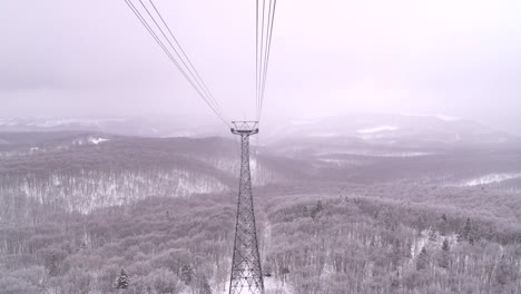 Ropeway-riding-down-high-above-snowy-winter-landscape