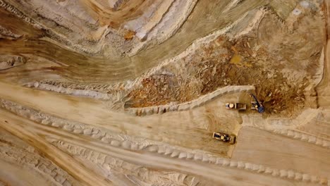 Drone-View-of-Trucks-and-a-Bulldozer-Quarrying-in-a-Rock-Quarry---Zoom-out