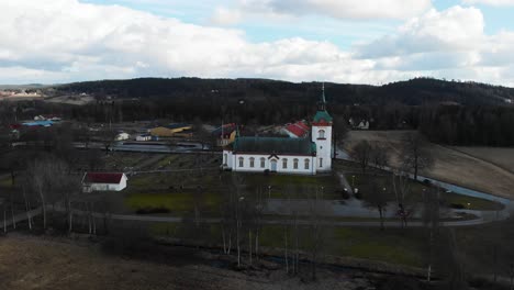 Drohne-Fliegt-In-Richtung-Bjorketorp-Kirche-Umgeben-Von-Kahlen-Bäumen-In-Der-Stadt-Ravlanda,-Harryda,-Schweden