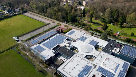 Aerial-overview-of-large-high-school-with-solar-panels-on-rooftop