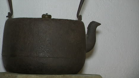 Cast-iron-kettle-rests-on-farmhouse-kitchen-shelf