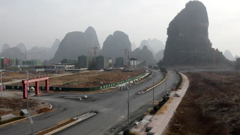Aerial:-city-construction,-Yangshuo-city-development-in-Chinese-countryside
