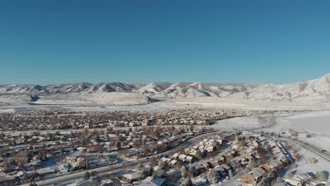 A-drone-pan-over-Lakewood-Colorado,-Red-Rock-in-the-distance